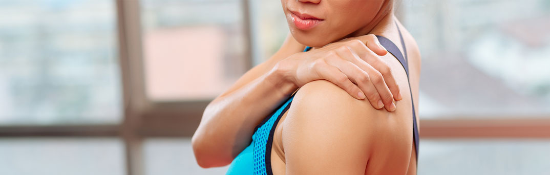 Woman holding shoulder.